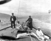 1575-View of helm and deck of Shamrock with crew. Colonel Neill on deck. c1900.