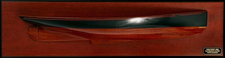 Mischief ( 1879 ) half hull wooden hand crafted.  Hand-crafted plank-on-frame wood hull with dark green topsides, red cove stripe . Varnished stained wood hull.